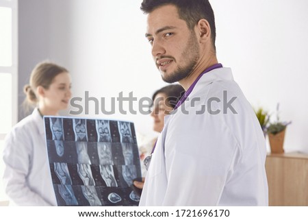 Doctor watching x-ray photography of elder woman