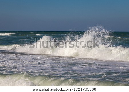 Big waves splashing on the coastline.