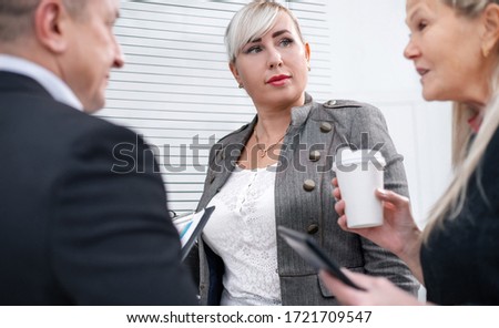 close up. businesswoman discussing with colleagues financial documents.