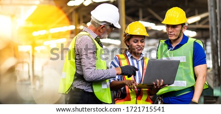 Professional Mechanical Engineer team Working on Personal Computer at Metal lathe industrial manufacturing factory. Engineer Operating  lathe Machinery. Product quality Inspection Royalty-Free Stock Photo #1721715541