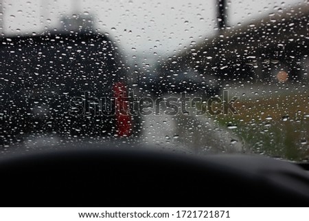 The dew drops on a car glass when it rains, traffic jam, lonely