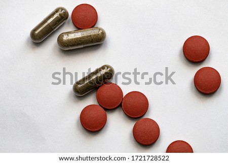 Different colorful tablets isolated on white background, close-up, selective focus