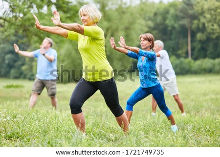 Seniors in the wellness class do Qi Gong or Tai Chi exercise for relaxation Royalty-Free Stock Photo #1721749735