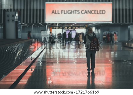 People leave the airport. girl walks through airport terminal. All flights are canceled. Ban on departure and arrival of aircraft due to covid-19 outbreak. Problems and crisis in aviation industry. Royalty-Free Stock Photo #1721766169