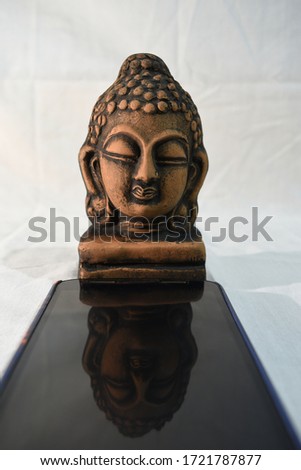 Pictures of Gautama Buddha on mobile screen