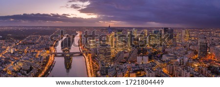 Panoramic aerial drone shot of la defense skyscraper complex with Eiffel tower and La seine during sunset