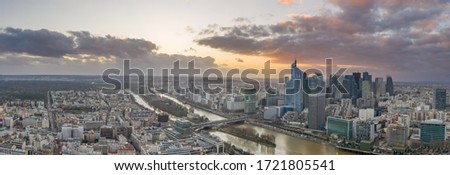 Panoramic aerial drone shot of la defense skyscraper complex with Eiffel tower and La seine during sunset