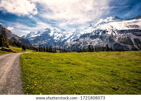 Route to amazing tourquise Oeschinnensee with waterfalls, wooden chalet and Swiss Alps, Berner Oberland, Switzerland. Royalty-Free Stock Photo #1721808073
