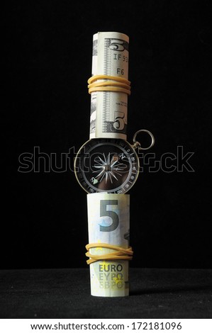 Orientation in Business Compass and Money on a Black Background
