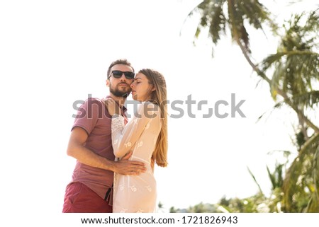 couple in love walk hands on the beach on the tropical island of Koh Samui in Thailand