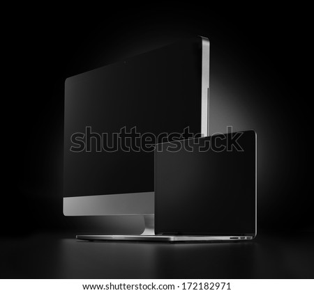 two computers with black screen on a dark background