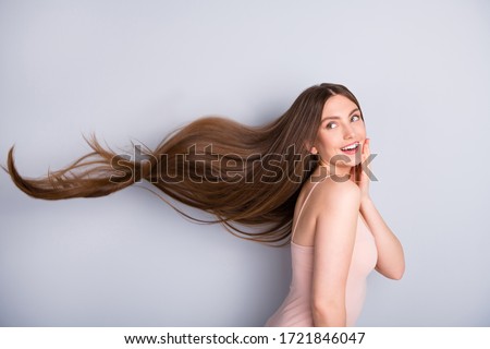 Profile photo of attractive cute model lady demonstrating ideal neat long healthy hairstyle flying on air after lamination procedure wear beige singlet isolated grey color background Royalty-Free Stock Photo #1721846047