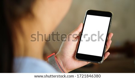 Cropped shot view of man hands holding smart phone with blank copy space screen for your text message or information content, female reading text message on cell telephone during in urban setting.  Royalty-Free Stock Photo #1721846380