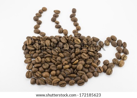 mug laid out by coffee grains on the isolated background
