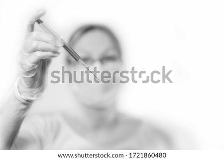 syringe injection from female blurred physician on white background