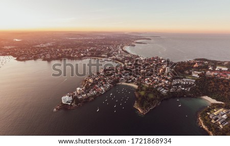 Aerial drone evening view of the Sydney suburb of Manly, in the state of New South Wales, Australia, with Manly Harbour, Little Manly & Collins Beaches and Manly & Northern Beaches on the ocean side.