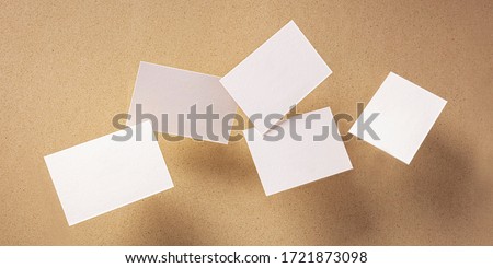 White thick business cards, flying on a brown paper background, a panoramic mock-up for design presentation Royalty-Free Stock Photo #1721873098