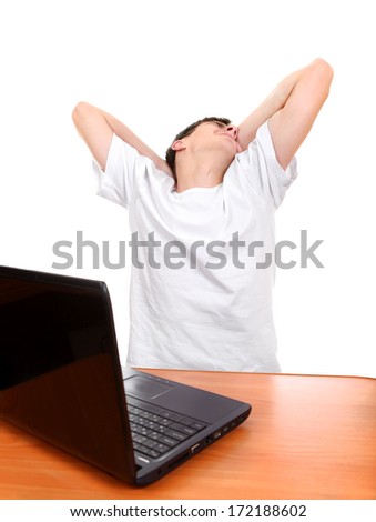Tired Young Man at the Desk with Laptop Isolated on the White Background