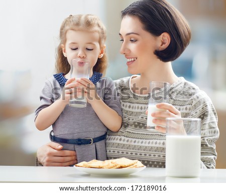 girl drinking milk at the kitchen Royalty-Free Stock Photo #172189016