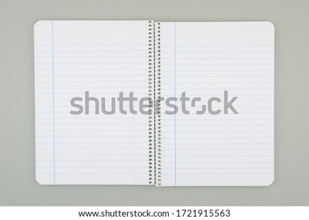 Notebook opened in half with line drawing, gray background