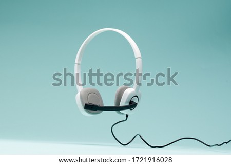 Headphones isolated on empty blue background. Royalty-Free Stock Photo #1721916028
