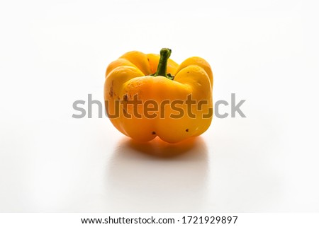 Damaged Yellow sweet pepper isolated on a white background