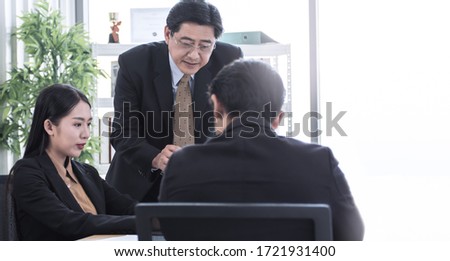 Banner of an asian group of business people meeting and planning their project in office. There is a copy space on the right side.