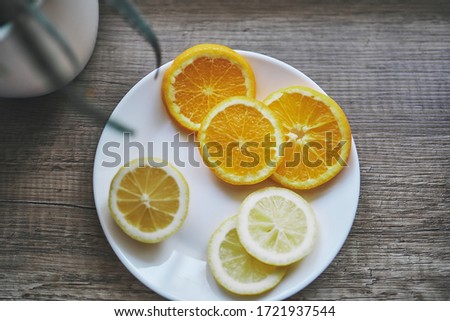 
sliced ​​slices of orange and lemon. white background for headline. fruit leaf. citruses. frame for text