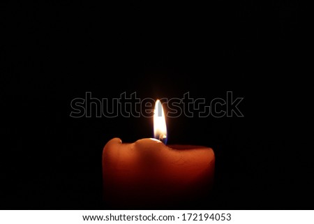 Burning candle on a black background Royalty-Free Stock Photo #172194053