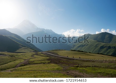 Beautiful view of the mountains of Kazbegi. Image with sunlight and selective focus.