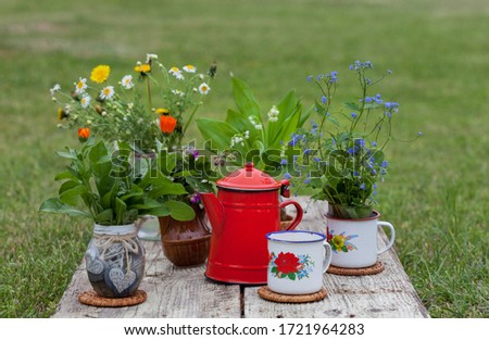 tea and coffee with spring flowers on a wooden table