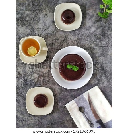 Chocolate pudding is a dessert with chocolate flavor that is boiled and then cooled, it can also be steamed or grilled according to taste and needs, flat lay, food photography. 
