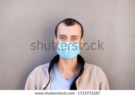 The image face of a young man wearing a medicine mask to prevent germs, toxic fumes, and dust. Prevention of bacterial infection Corona virus or Covid 19.