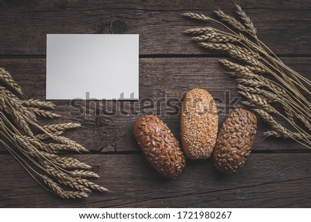 Close up of mockup blank on background of homemade bread making. Mockup of brochure or greeting card in harvest composition with empty place for text. Top view