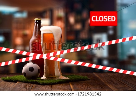 Closed due to a pandemic. Premises of pub are covered with red and white ribbon. Concept of closing public places