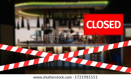 Closed due to pandemic. Premises of cafe are covered with red and white ribbon. Concept of closing public places