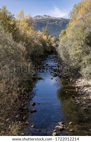river in the pyrenees with mountains in the background