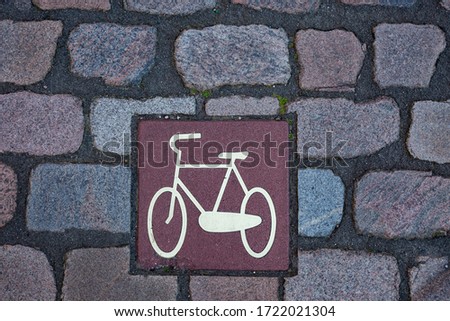 Symbol for bicycle lane on a colored cobblestone