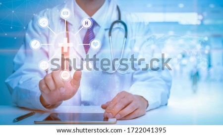 Close up of Doctor is touching digital virtual screen for analytics Medical data , Medical technology concept