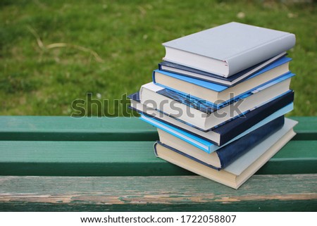 Stack of books on the bench at the school park