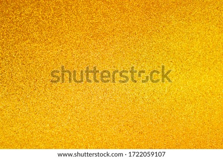 Defocused background of shining sparkles, abstract golden light.
