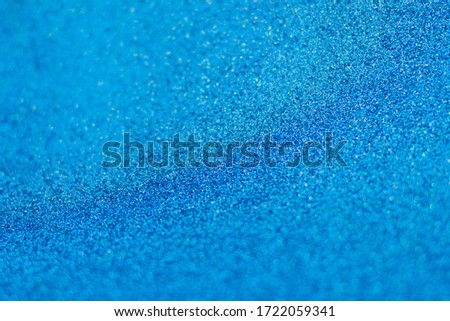 Defocused background of shining sparkles, abstract blue light.