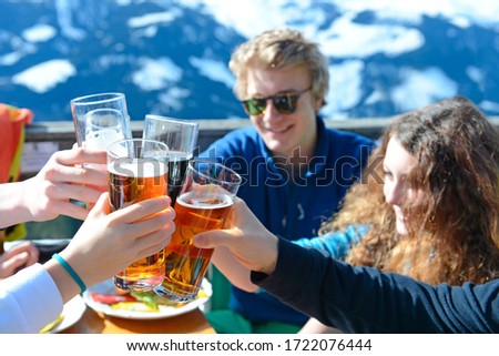 Teenagers enjoying soft drinks and lunch on skiing holiday, Tirol, Austria, Europe