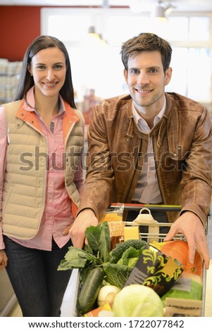 Couple shopping in an organic grocery store, portrait