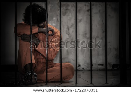 Asian man desperate at the iron prison,prisoner concept,thailand people,Hope to be free,Serious prisoners imprisoned in the prison Royalty-Free Stock Photo #1722078331