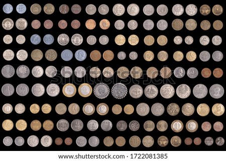 Set of different coins on a black background. Stock photo assortment of coins of different countries. 