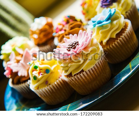Horizontal colour image of cupcakes on a plate