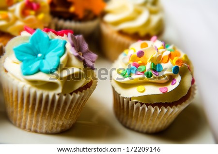 Horizontal colour image of cupcakes on a plate