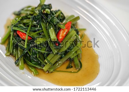 Thai food, Stir-fry water spinach (pad pak bung fai daeng). Royalty-Free Stock Photo #1722113446
