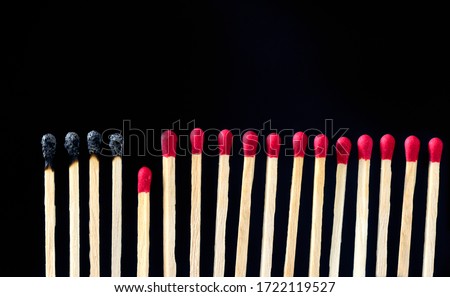 matchsticks burnt in row as sequence while one match stay down from burning to avoid fire connecting against black background, social stop pandemic concept. Royalty-Free Stock Photo #1722119527